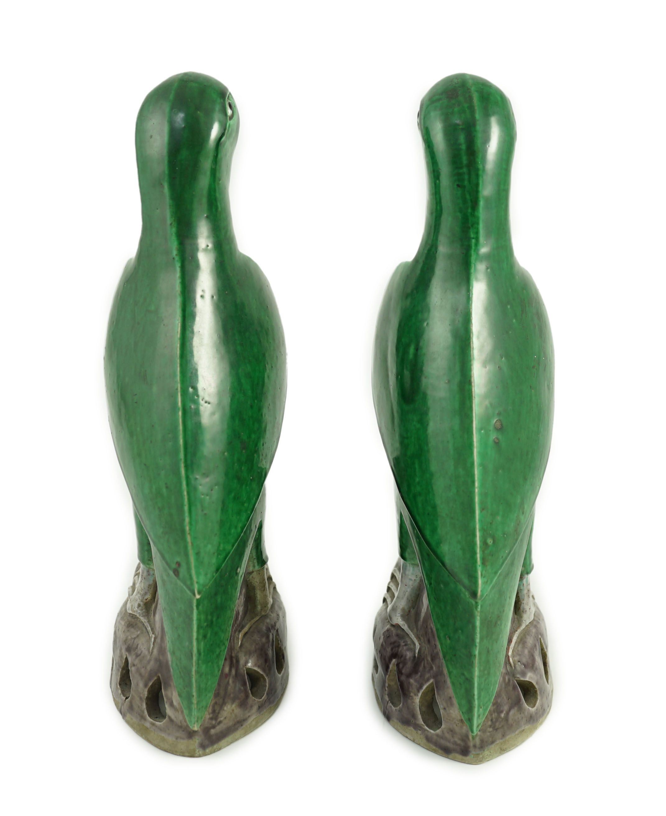 A pair of Chinese green and aubergine glazed models of parrots, 19th century, 27.5cm high